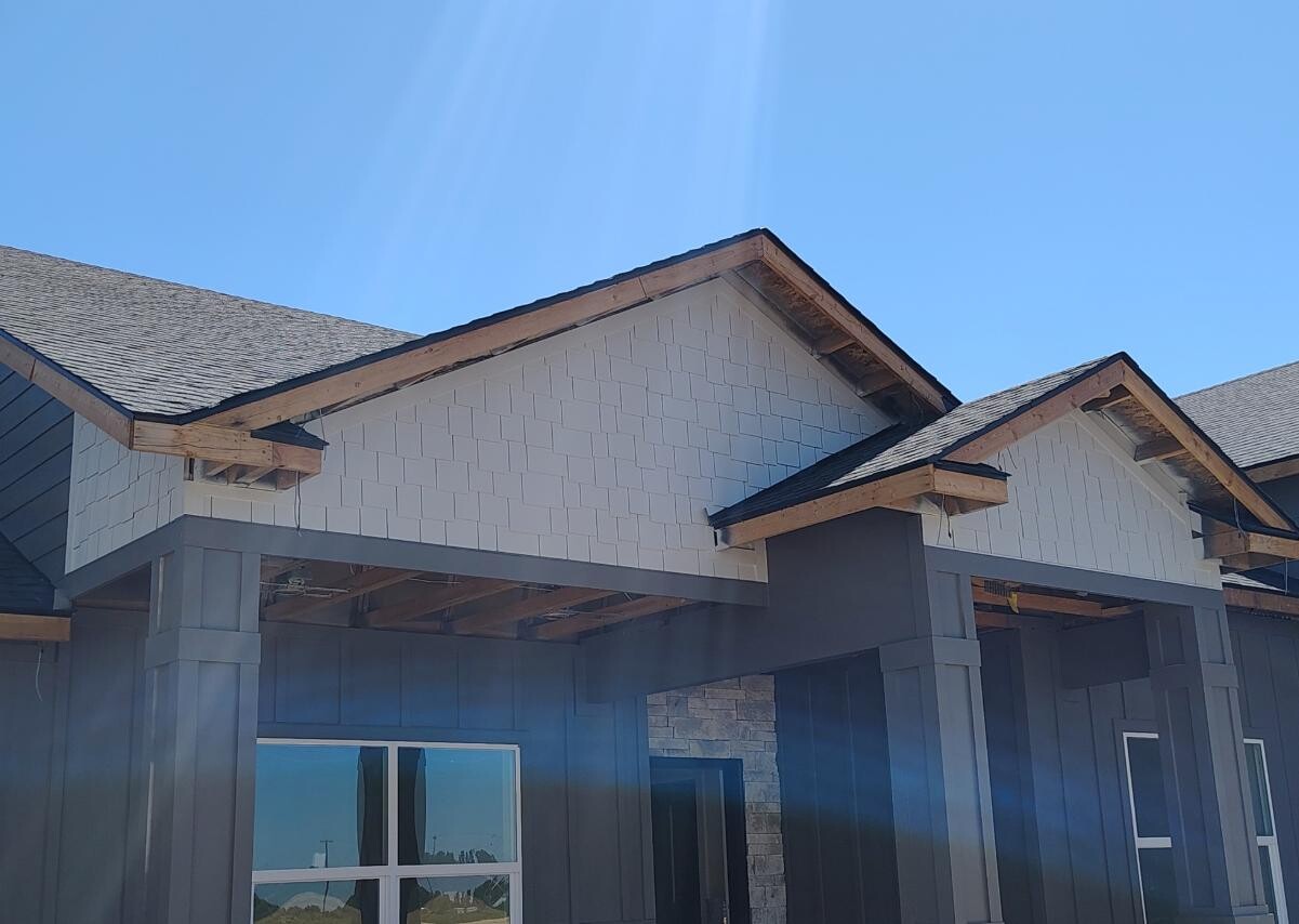 Exterior house painting with white shingle siding and stone accents in Twin Falls Idaho